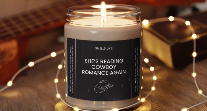 shes reading cowboy romance again candle.jpg.optimal