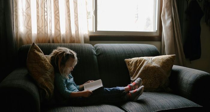 child reading on couch.jpg.optimal