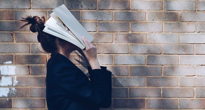 woman with book over face.jpg.optimal